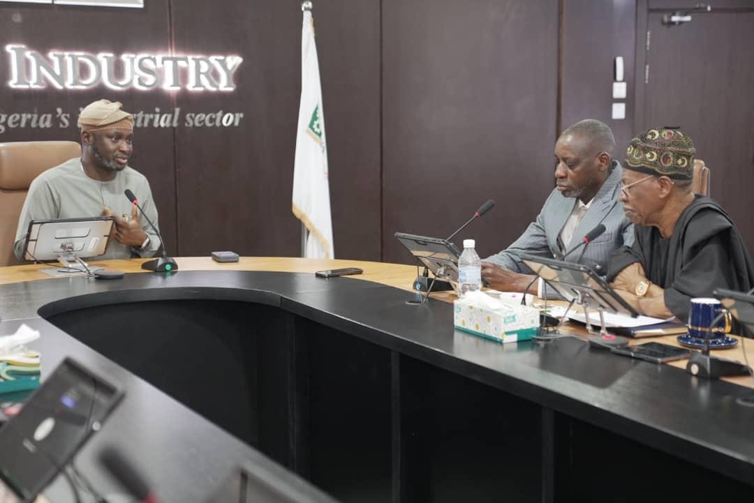 The Managing Director of the Bank of Industry, Dr. Olasupo Olusi, addressing Prof. Ayo Omotayo and Alhaji Lai Mohammed at the bank's corporate headquarters in Lagos.